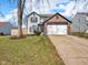 Charming two-story home with a brick front, attached two-car garage, and a well-maintained lawn at 11054 Dura Dr, Indianapolis, IN 46229