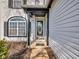 Charming front porch with decorative columns and an oval window door at 11054 Dura Dr, Indianapolis, IN 46229