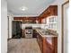 Well-equipped kitchen featuring stainless steel appliances, cherry cabinets, and granite countertops at 11054 Dura Dr, Indianapolis, IN 46229