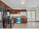 Well-equipped kitchen featuring stainless steel appliances, cherry cabinets, and granite countertops at 11054 Dura Dr, Indianapolis, IN 46229