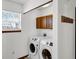 Laundry room featuring newer washer and dryer, storage cabinet, and natural light at 11054 Dura Dr, Indianapolis, IN 46229
