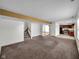 Open-concept living room showcases staircase, hardwood floors, and seamless transitions between living spaces at 11054 Dura Dr, Indianapolis, IN 46229