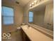 Bright bathroom featuring a large vanity and natural light from the window at 11663 Congressional Ln, Indianapolis, IN 46235