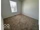 Bright bedroom with neutral carpeting and window at 11663 Congressional Ln, Indianapolis, IN 46235