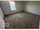 Bedroom featuring neutral carpet and a window allowing natural light at 11663 Congressional Ln, Indianapolis, IN 46235