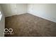 Primary bedroom with neutral carpet and multiple doors at 11663 Congressional Ln, Indianapolis, IN 46235