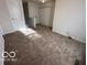 Second bedroom with neutral carpet and doors to other rooms at 11663 Congressional Ln, Indianapolis, IN 46235