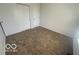 Bedroom featuring neutral carpet and white walls, complete with a closet for optimal storage solutions at 11663 Congressional Ln, Indianapolis, IN 46235