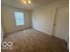 Cozy bedroom with plush carpeting and a bright window for natural lighting at 11663 Congressional Ln, Indianapolis, IN 46235