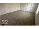Bedroom featuring neutral carpet and a window allowing natural light at 11663 Congressional Ln, Indianapolis, IN 46235