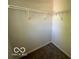 A closet with built in shelving and neutral colored carpet at 11663 Congressional Ln, Indianapolis, IN 46235