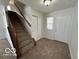 Bright entryway with stairs, double closets, and neutral-toned flooring at 11663 Congressional Ln, Indianapolis, IN 46235