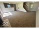 Open living room with neutral carpet and natural light from the adjacent windows at 11663 Congressional Ln, Indianapolis, IN 46235