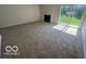 Living room with a fireplace, carpet, and natural light at 11663 Congressional Ln, Indianapolis, IN 46235