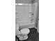 Bathroom with a shower/tub combo, toilet, and dark gray floor tiles at 1401 N Pershing Ave, Indianapolis, IN 46222