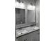 Double vanity bathroom with gray countertop and updated lighting at 1401 N Pershing Ave, Indianapolis, IN 46222
