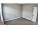 Simple bedroom with gray walls, neutral carpeting, and a window at 1401 N Pershing Ave, Indianapolis, IN 46222