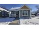 Charming craftsman style home with gray siding and a snowy front yard at 1401 N Pershing Ave, Indianapolis, IN 46222
