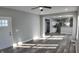 Open living room with hardwood floors, looking toward the kitchen at 1401 N Pershing Ave, Indianapolis, IN 46222