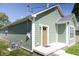 Green home with an outdoor patio, perfect for entertainment and relaxation in the backyard at 1407 N Pershing Ave, Indianapolis, IN 46222