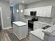 Modern kitchen with white cabinets and an island at 1407 N Pershing Ave, Indianapolis, IN 46222