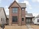 New two-story home featuring brick and cedar siding and black-trimmed windows at 17333 Ackerson Blvd, Westfield, IN 46074