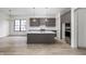 Modern kitchen with gray cabinetry, quartz countertops, and a large island at 17333 Ackerson Blvd, Westfield, IN 46074
