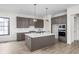 Modern kitchen with gray cabinetry, quartz countertops, and island at 17333 Ackerson Blvd, Westfield, IN 46074