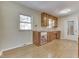 Kitchen with wood cabinets, white appliances, and light wood floors at 1844 Averitt Rd, Greenwood, IN 46143