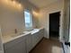 Bright bathroom featuring double vanity with quartz countertops and modern fixtures at 19983 Boulder Brook Ln, Westfield, IN 46074