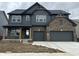 Charming two-story home features brick and gray wood, two-car garage, and stylish architectural details at 19983 Boulder Brook Ln, Westfield, IN 46074