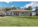 Ranch home with stone exterior, landscaped lawn, and detached garage at 2003 S Bolton Ave, Indianapolis, IN 46203