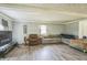 Living room with hardwood floors, sectional sofa, and recliner at 2003 S Bolton Ave, Indianapolis, IN 46203