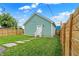 Landscaped backyard with detached garage and stone path at 2015 Columbia Ave, Indianapolis, IN 46202