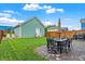 Backyard patio with seating area and detached garage at 2015 Columbia Ave, Indianapolis, IN 46202