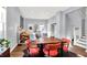 Bright dining area with wooden table and four coral chairs at 2015 Columbia Ave, Indianapolis, IN 46202