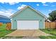 Detached garage with white door and light green exterior at 2015 Columbia Ave, Indianapolis, IN 46202