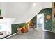L-shaped hallway with green leaf wallpaper, built-in shelving, and comfortable seating at 2015 Columbia Ave, Indianapolis, IN 46202