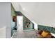 L-shaped hallway with green leaf wallpaper, built-in shelving, and comfortable seating at 2015 Columbia Ave, Indianapolis, IN 46202