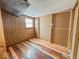 Small bedroom with wood paneling and flooring at 216 W 27Th St, Anderson, IN 46016