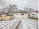 Small ranch home with wooden fence and snowy yard at 216 W 27Th St, Anderson, IN 46016