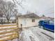 Small ranch home with damaged roofline and snowy yard at 216 W 27Th St, Anderson, IN 46016