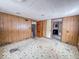 Living room with wood paneling and star patterned floor at 216 W 27Th St, Anderson, IN 46016
