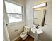 Updated bathroom with pedestal sink, new toilet, and modern vanity lighting at 2526 Pleasant W Way, Carmel, IN 46280