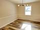 Bright dining room features hardwood floors and a modern light fixture at 2526 Pleasant W Way, Carmel, IN 46280