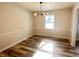 Bright dining room features hardwood floors and a modern light fixture at 2526 Pleasant W Way, Carmel, IN 46280