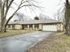 Ranch style home with stone facade, attached garage, and mature trees at 2526 Pleasant W Way, Carmel, IN 46280