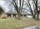 Ranch style home with stone facade, attached garage, and mature trees at 2526 Pleasant W Way, Carmel, IN 46280