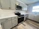 Modern kitchen with gray cabinets, quartz countertops, and stainless steel appliances at 2526 Pleasant W Way, Carmel, IN 46280