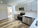 Modern kitchen with gray cabinets, quartz countertops, and stainless steel appliances at 2526 Pleasant W Way, Carmel, IN 46280